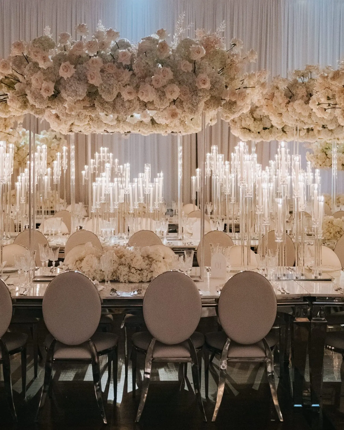 Floating Blush Canopy - Suspended blush and ivory rose canopy above mirrored long tables and towering crystal taper candelabras by Aura Design Flowers Miami