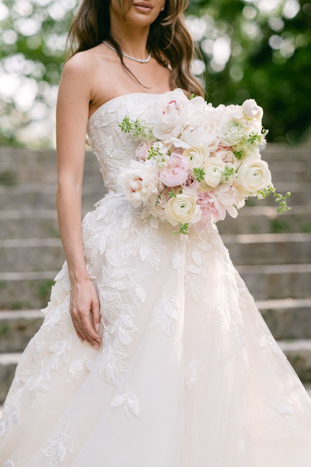 bride holding lush white peony and blush ranunculus bridal bouquet miami