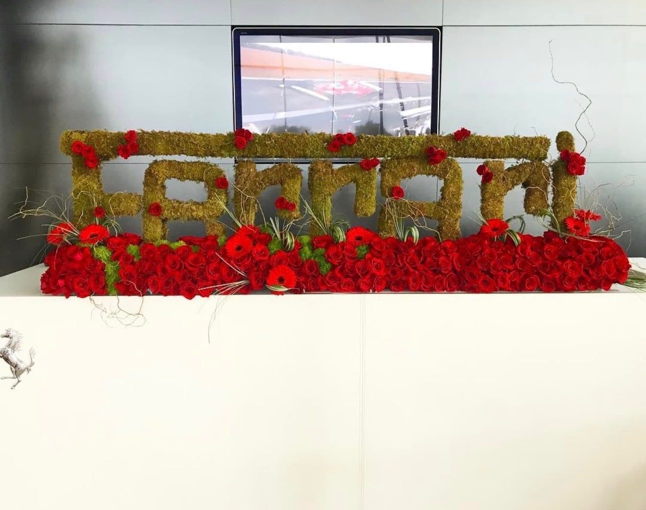 Ferrari corporate event florals by Aura Design Flowers Ferrari corporate event florals in Miami: custom Ferrari logo floral sculpture in moss, red roses and gerbera daisies by Aura Design Flowers