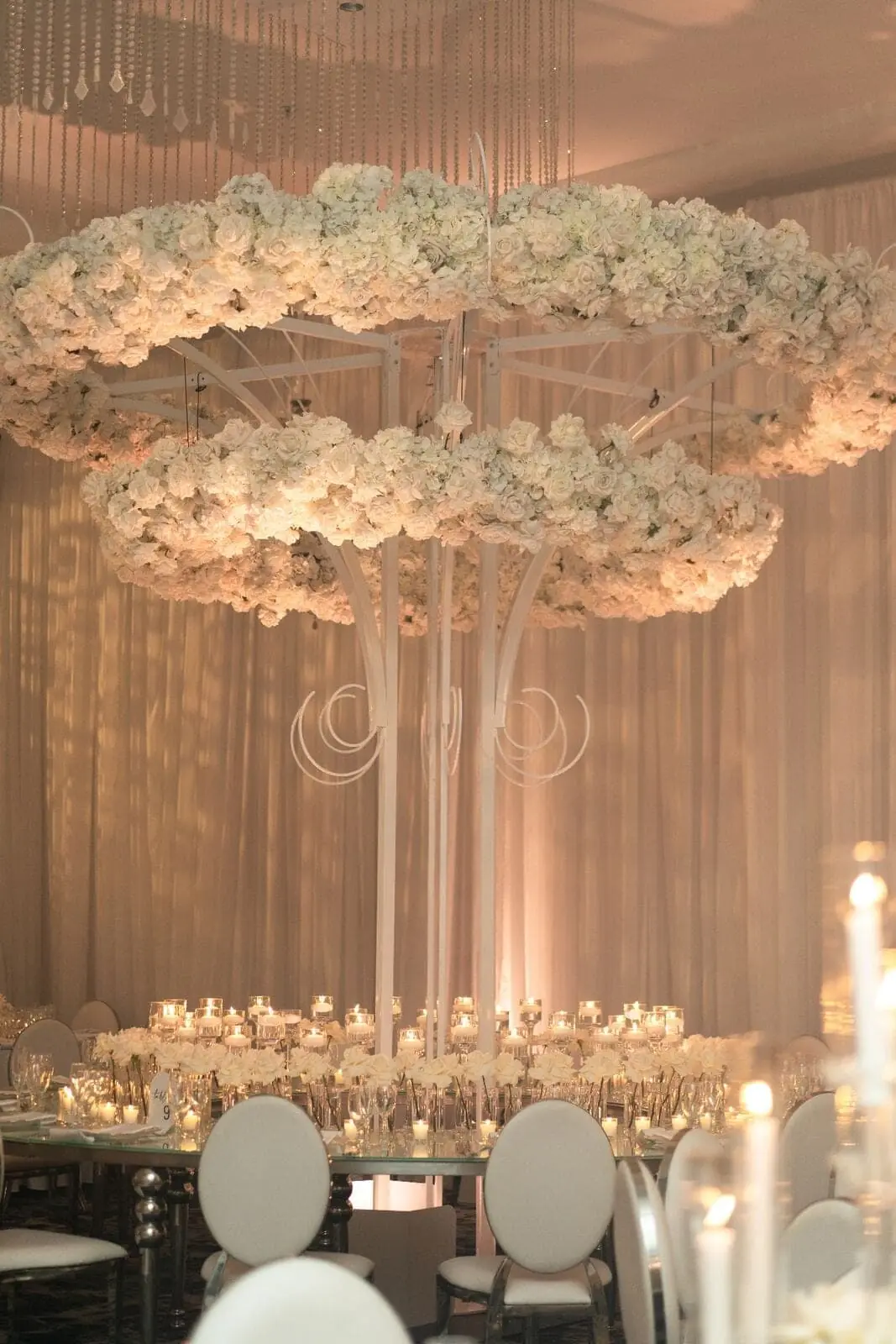Grand Table Arrangement - Towering white rose and hydrangea centerpiece with cascading crystal accents by Aura Design Flowers Miami