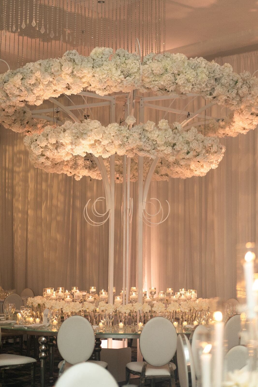 Grand Table Arrangement - Towering white rose and hydrangea centerpiece with cascading crystal accents by Aura Design Flowers Miami