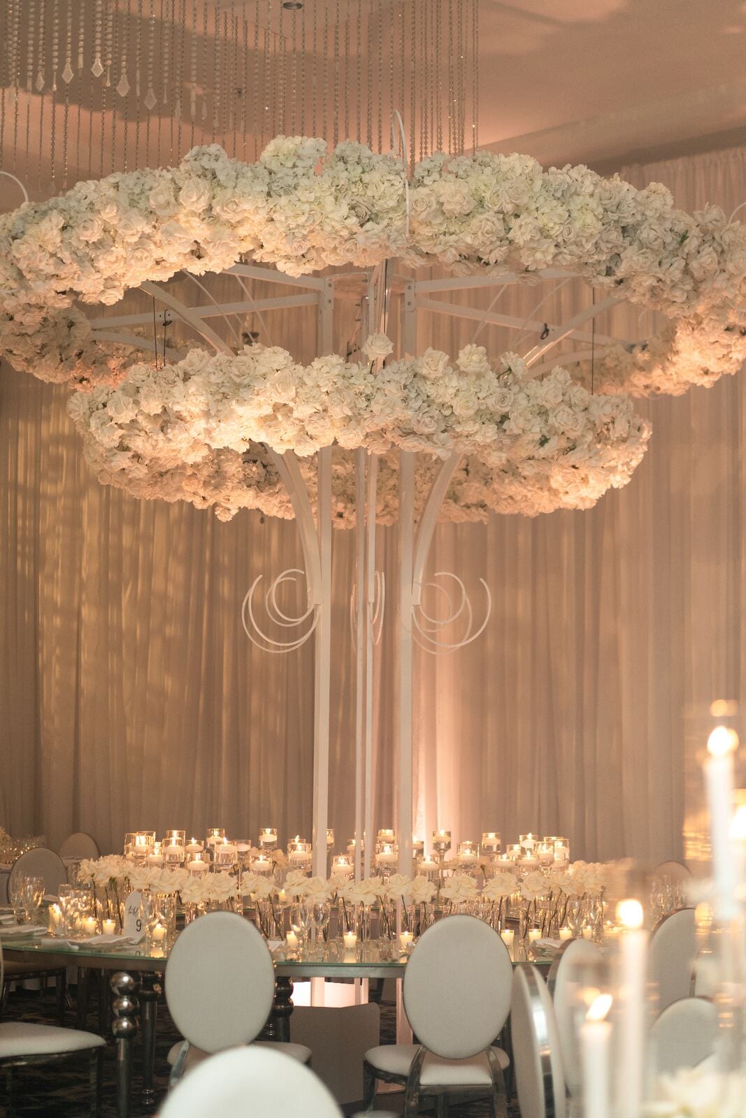 Grand Table Arrangement - Towering white rose and hydrangea centerpiece with cascading crystal accents by Aura Design Flowers Miami