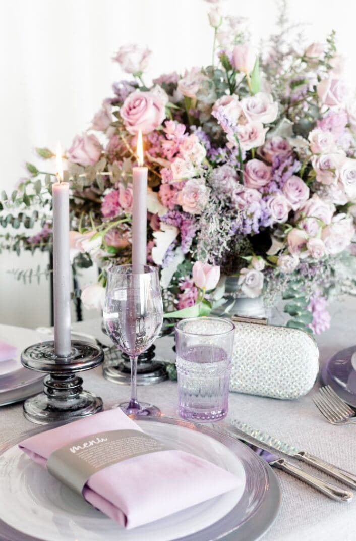 Romantic lavender rose centerpiece with taper candles and lilac glassware editorial tablescape - lavender photoshoot