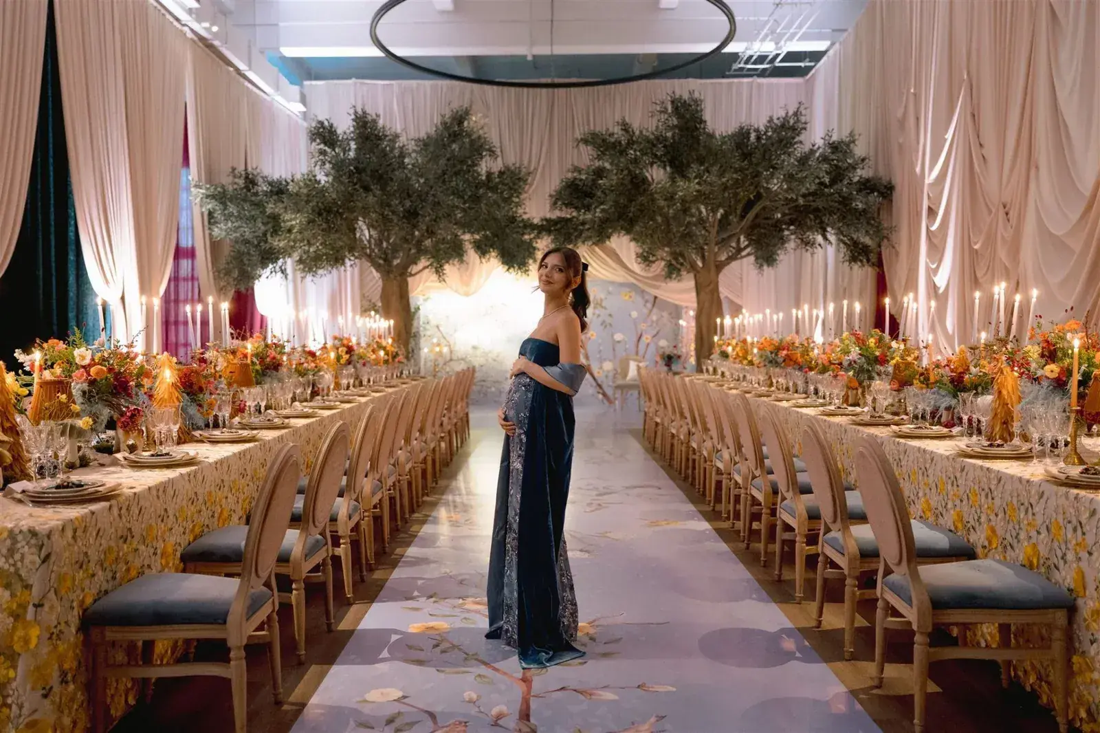 Enchanted garden baby shower with olive trees, draped fabric, and lush wildflower tablescape in Miami