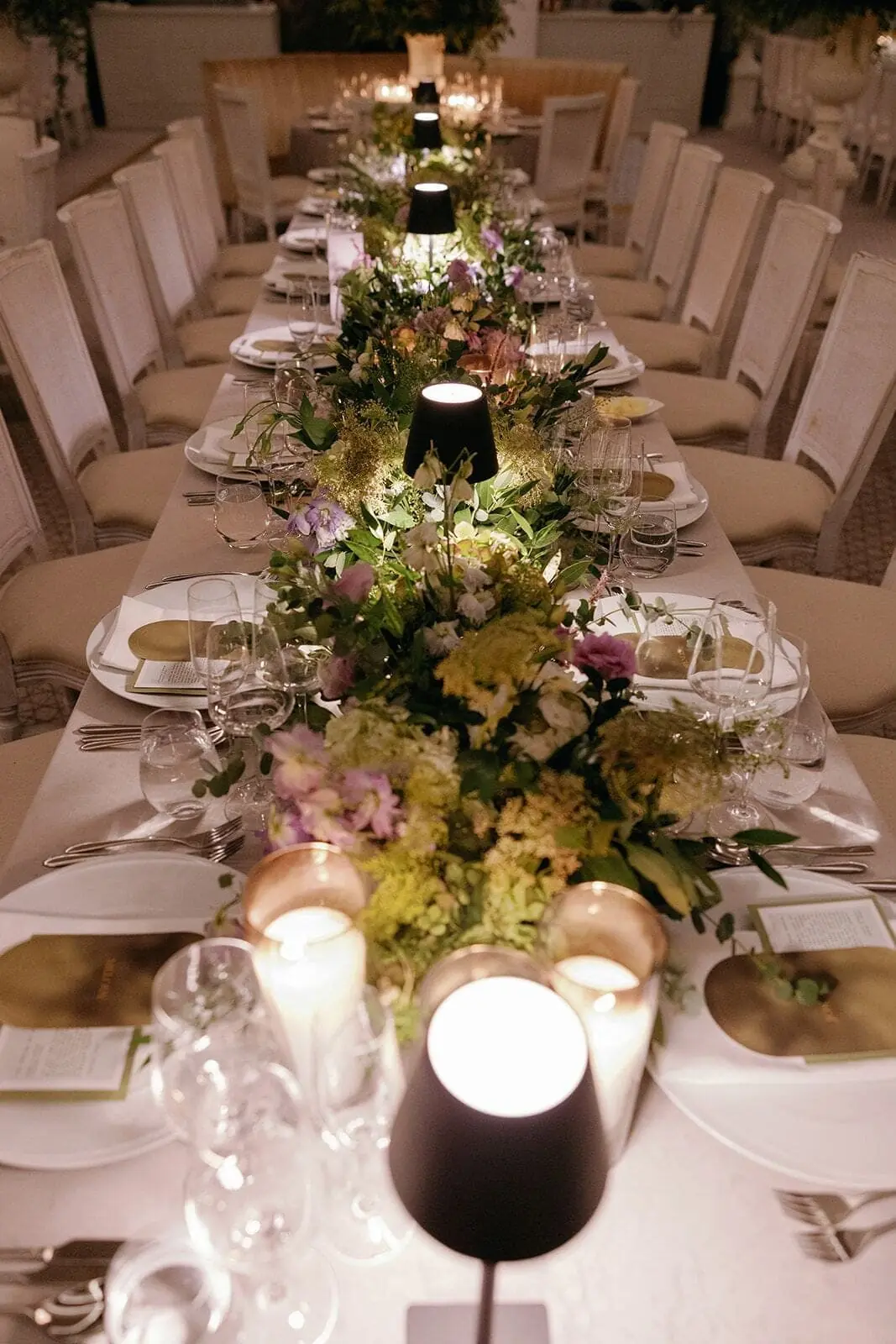 Garden Table Runner - Lush pastel floral runner glowing with candlelight along a long banquet table by Aura Design Flowers Miami