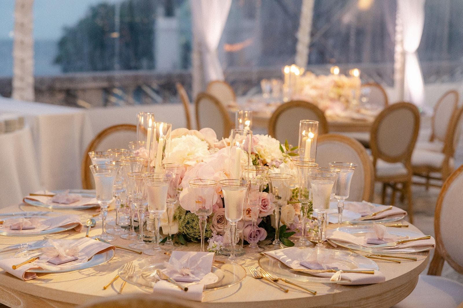 Bride and groom embrace beside cascading white florals and chandeliers at St. Regis Bal Harbour