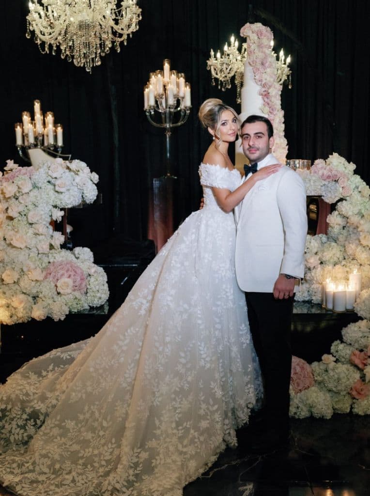 Black Tie Reception - Dramatic chandelier backdrop with towering floral cake by Aura Design Flowers Miami