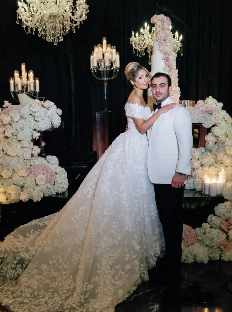 Black Tie Reception - Dramatic chandelier backdrop with towering floral cake by Aura Design Flowers Miami