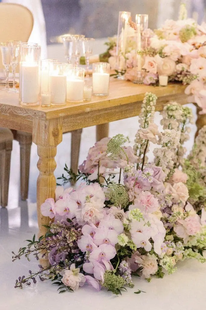 Floral Cascade - Lavish orchid arrangements spilling from the table by Aura Design Flowers Miami