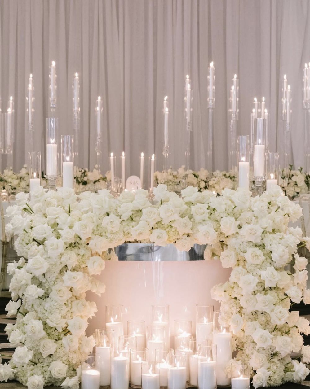 Luxury white rose sweetheart table with candlelight at Miami wedding