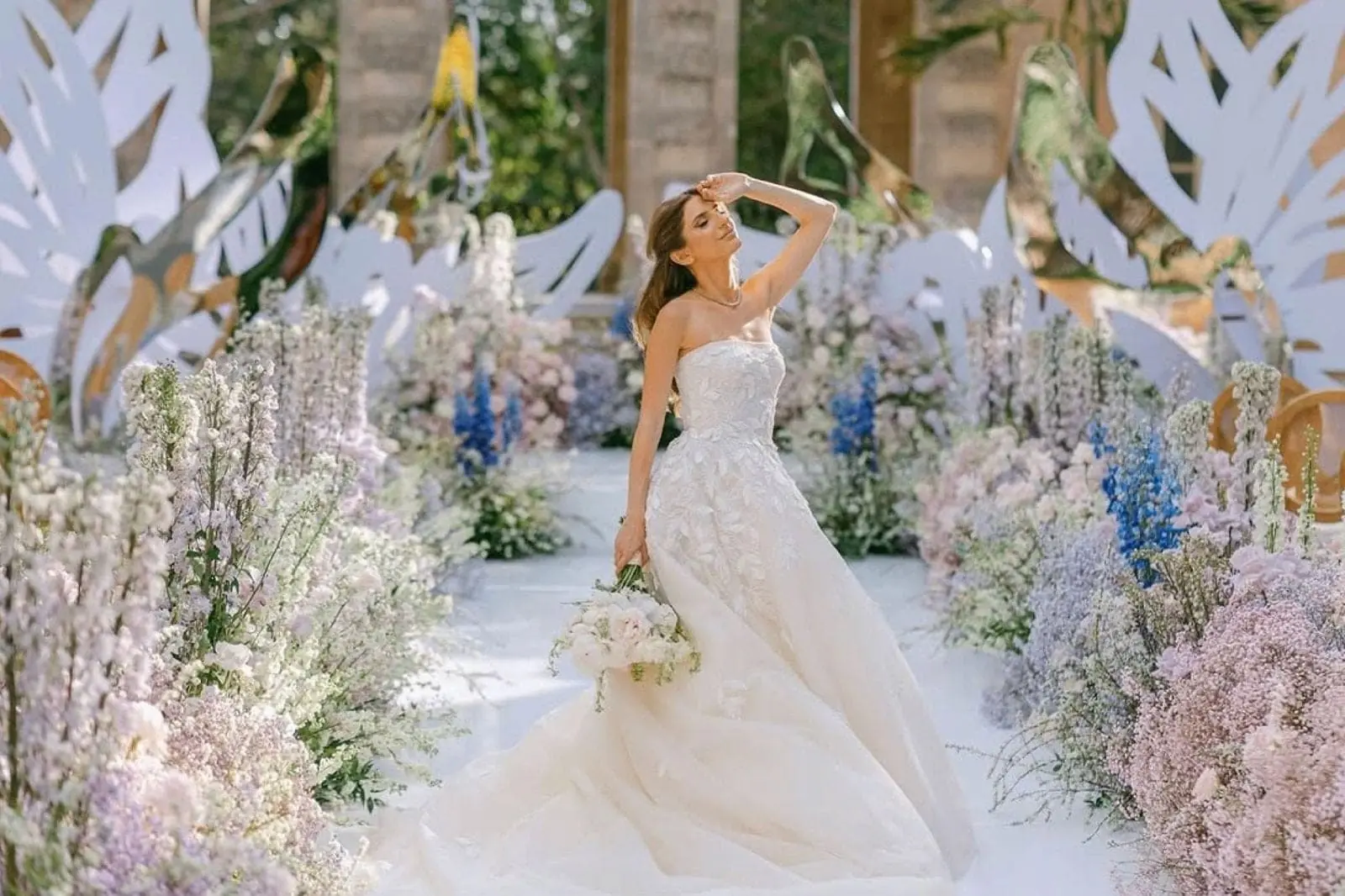 Bride surrounded by lavender and blue floral ceremony installation at Miami Beach wedding