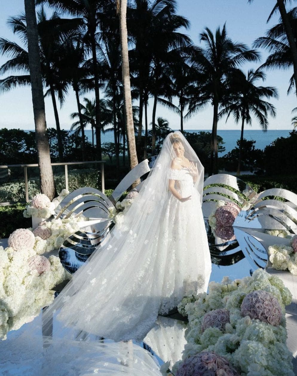 Oceanfront bridal portrait with sculptural floral arch in Miami