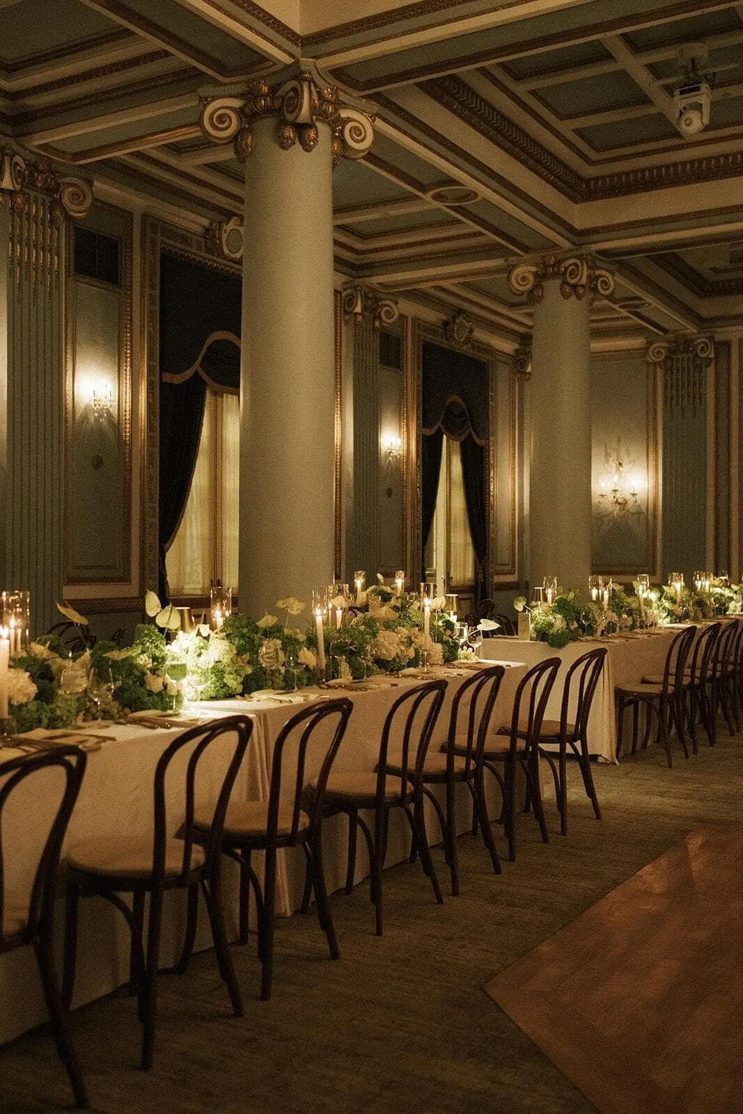 Heritage Ballroom Tablescape - Long ivory tables with greenery garlands and taper candles in a gilded ballroom by Aura Design Flowers Miami