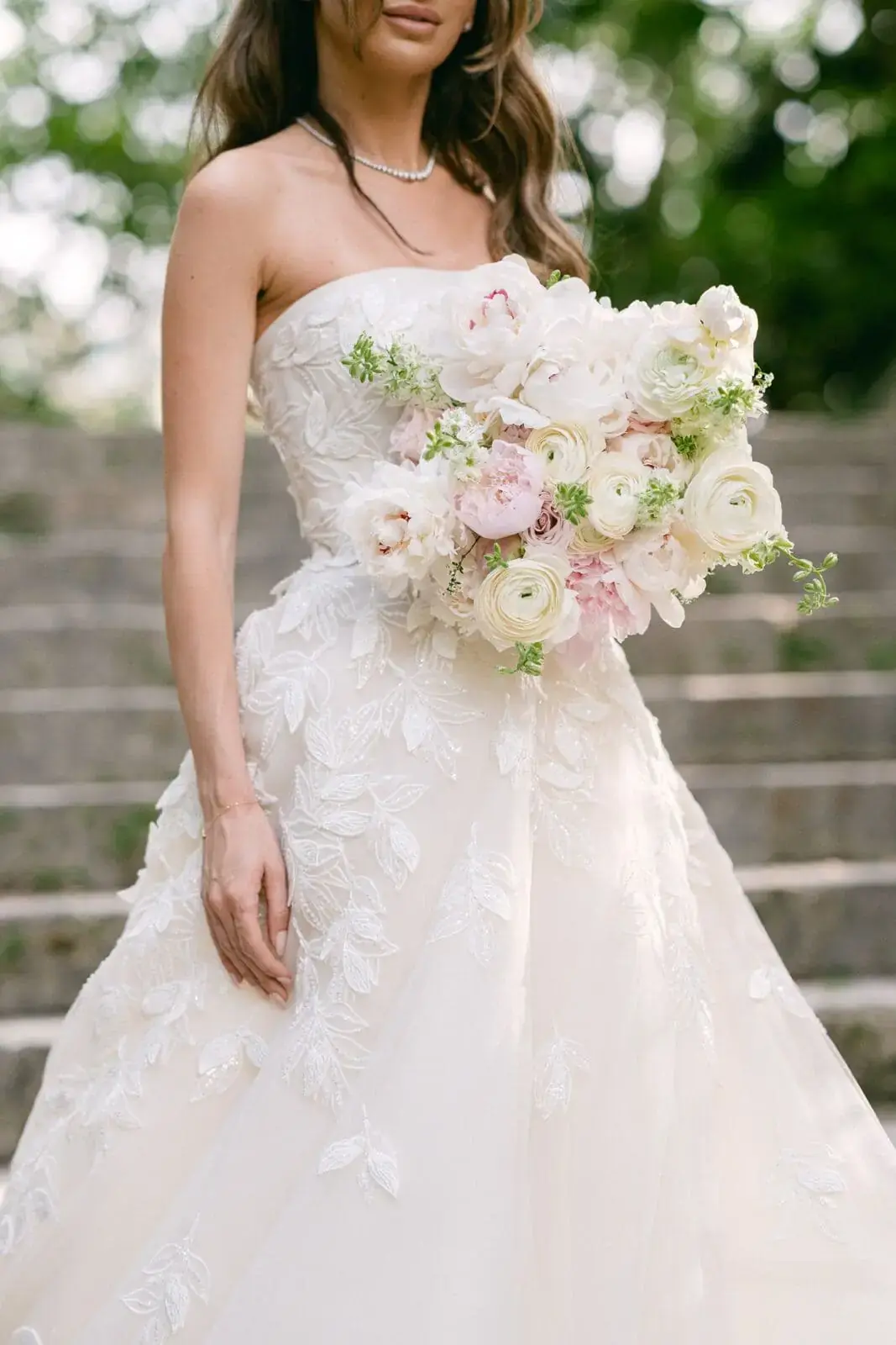 Bride holding an elegant white and blush bridal bouquet at a Miami wedding