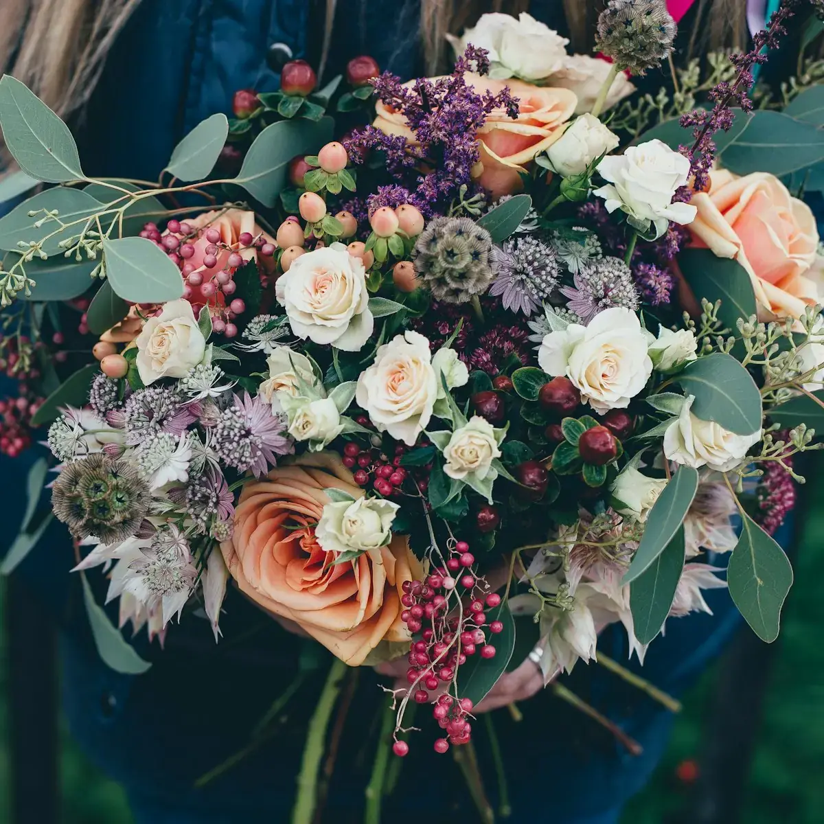 Lush garden-style wedding floral arrangement with peonies and ranunculus at a Miami venue